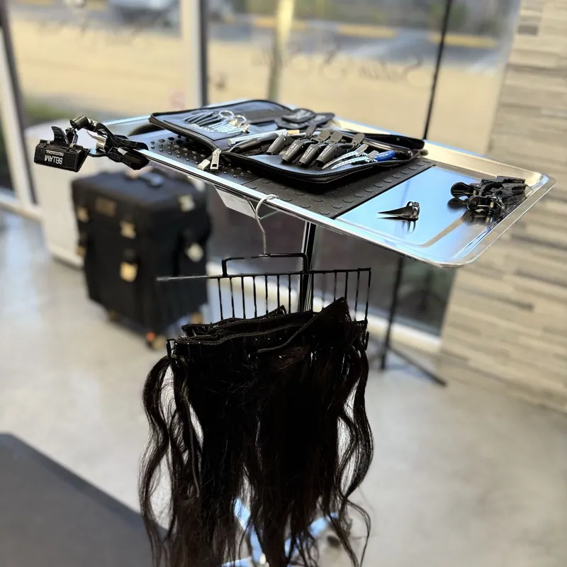 Tape-in extension wefts prepared on a stand before installation