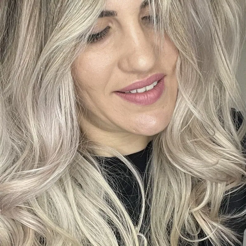 A happy client with bright blonde hair