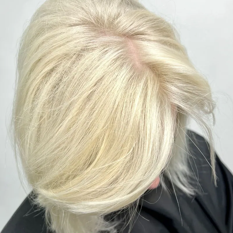 A crown of freshly toned platinum hair, seen from above